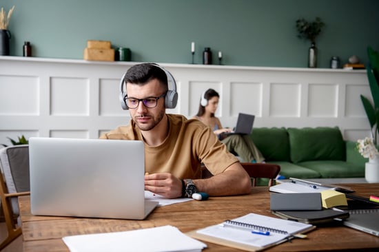 young-man-listening-music-during-study-session